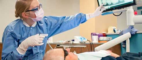 dental therapist with patient