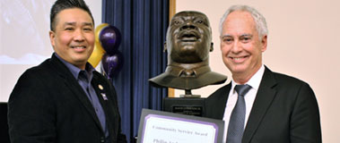 Dr. Philip Anderson (right) receives his award from Butch de Castro of the MLK Tribute planning committee.