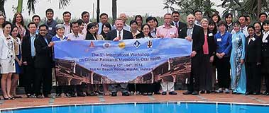 group of people holding banner by pool