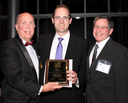 Dr. Vincent Kokich Jr. (center) accepts his late father’s Honorary Lifetime Member Award from Dr. Douglas Walsh (left) and Dr. Peter Shapiro.