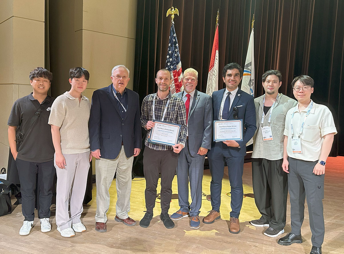 Students and Dr. Newman after AGD e-poster award ceremony with AGD President Dr. Merlin Ohmer