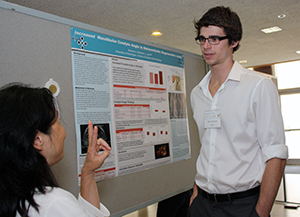 Alexander Stanton discusses his research during poster presentations at the School of Dentistry’s Research Day in 2014. 