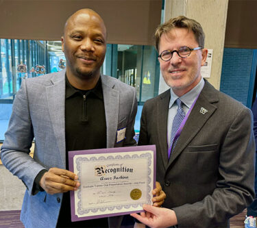 Dr. Fashina receives his second-place award at the 2026 Research Day.