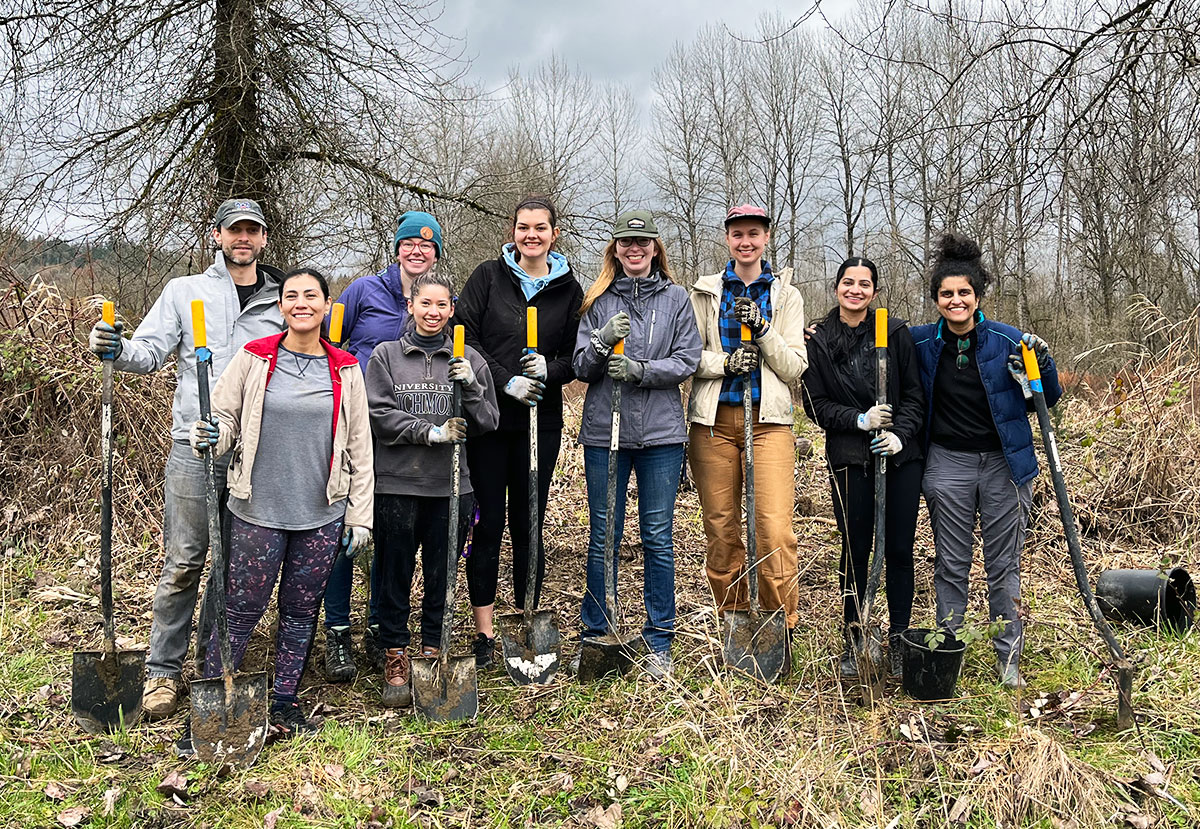 CAST team members planting trees on the Snoqualmie riverbank at an ‘Adopt-a-buffer event.