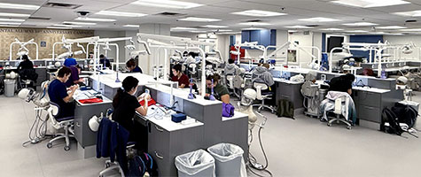 Students working at a station in the D165 Sim Lab.