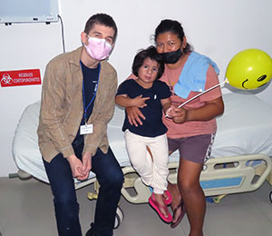 Dr. Austin Gaal with one of his patients and their mother.