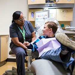 Dentist with boy in the dental chair