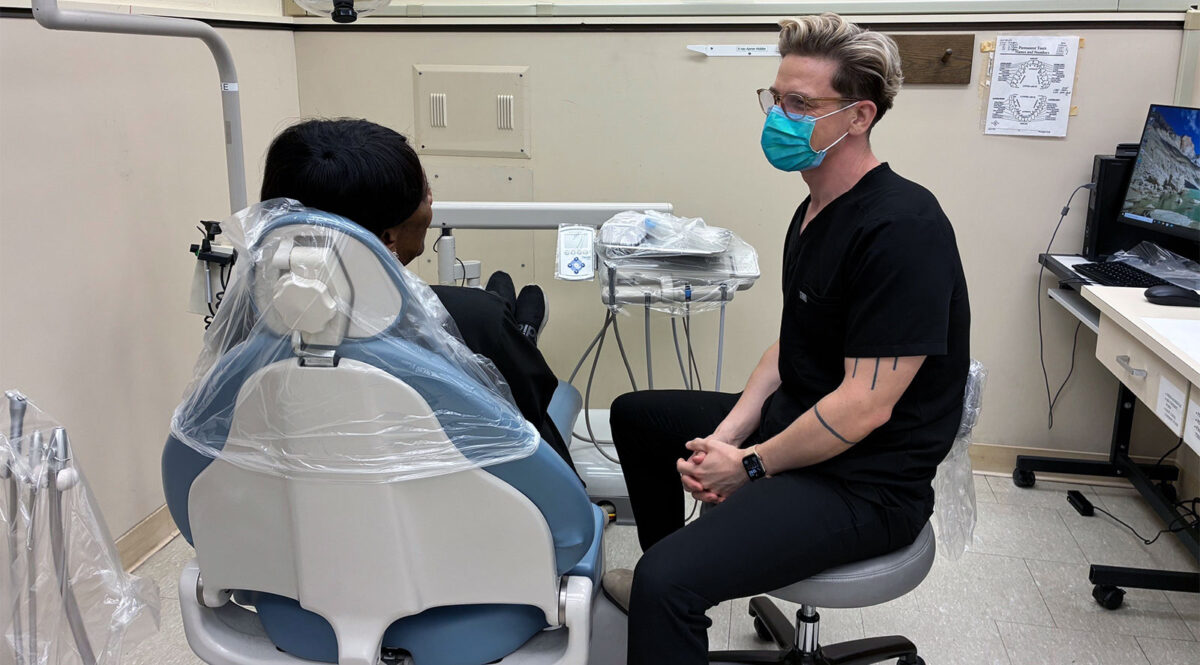 UWSOD student talks with a patient referred to the School by the KCADP.