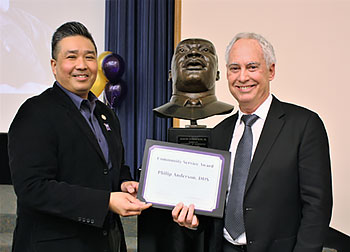 Dr. Philip Anderson (right) receives his award from Butch de Castro of the MLK Tribute planning committee.