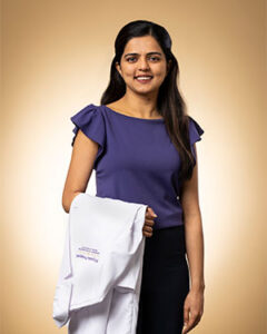 Priyanka Prajapati with white coat