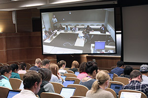 RIDE students in Spokane (on video monitor), shown taking a test with their Seattle classmates, are connected to the School of Dentistry by distance-learning technology.