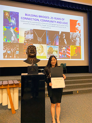 Tang accepts her Martin Luther King, Jr. Community Service award at the celebration event.