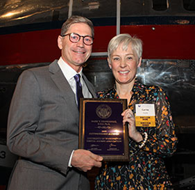 Dr. Mark Drangsholt receives his Distinguished Alumnus Award from Dr. Carrie York, chair of the award selection committee.
