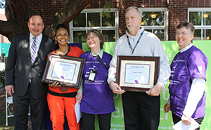 Dean Joel Berg of the School of Dentistry (far left), Dr. Rebecca Slayton (far right) and Center social worker Heather Marks (center) present Barrier Buster awards to Daphne Pie of Seattle King County Public Health Outreach and Terry May of Paratransit.