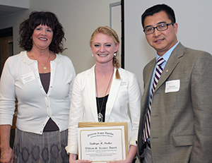 Phillips and Dr. Zhang present the William S. Kramer Award for Excellence to rising third-year student Kathryn Parker. 