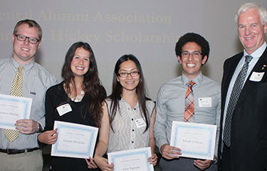 Students holding scholarship certificates