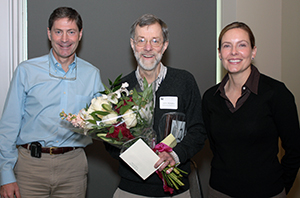 Dr. John Wataha (center) receives his Rothwell Teaching Award from Dr. Mark Drangsholt and Tracey Hawk.