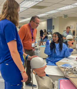 Dare to Dream student shows the tooth she was working on.