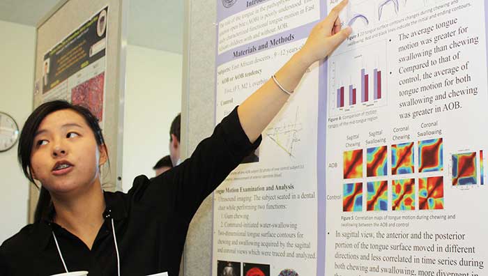 Student with research poster