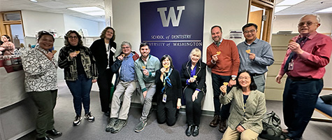 Faculty and staff celebrate after CODA visit