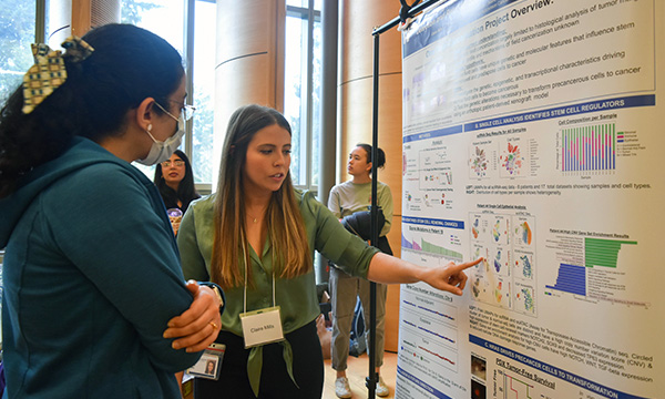 Student at posterboard for Research Day