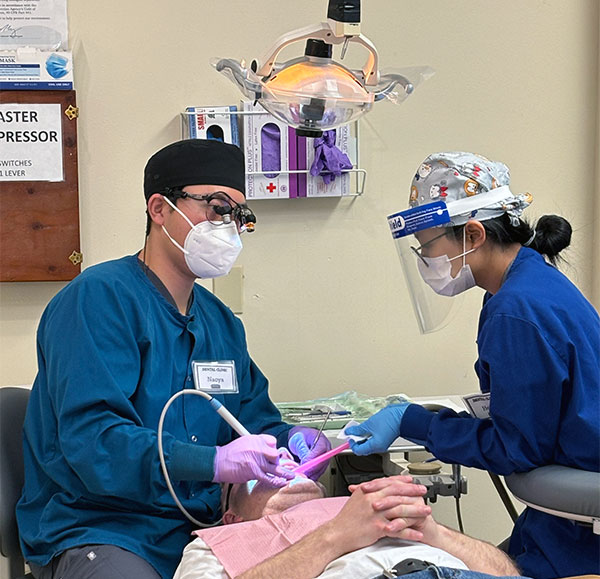 Two students working on a patient
