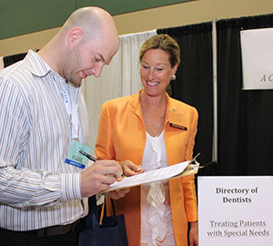 At the 2011 Pacific Northwest Dental Conference in Seattle, Kimberly Hanson Huggins welcomed Dr. David Dean of Tukwila as she surveyed area dentists about providing care for patients with special needs.