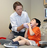 Dr. Travis Nelson treats a young patient in his autism clinic at The Center for Pediatric Dentistry.