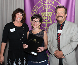 Sandi Phillips (left), chapter vice president, and Dr. Mats Kronstrom congratulate honorary faculty inductee Diane Daubert. 
