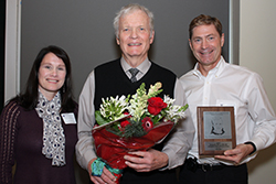 Dr. Richard McCoy receives the Bruce R. Rothwell Lifetime Distinguished Teacher Award from Dr. Mark Drangsholt and Rebecca Rothwell. 